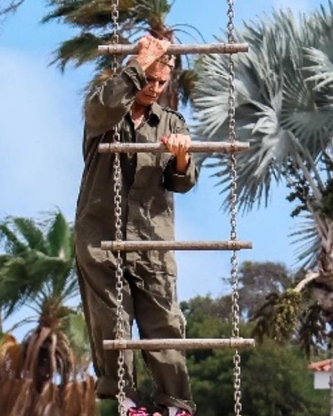 Linda on an obstacle course rope ladder